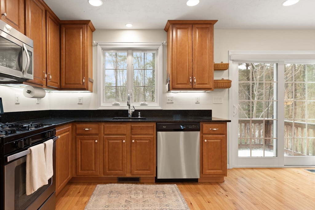 41 Boston Road, Unit 485 Billerica, MA 01862 - Photo 4 of 19 a kitchen with stainless steel appliances granite countertop a sink stove and microwave