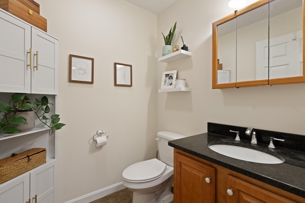 41 Boston Road, Unit 485 Billerica, MA 01862 - Photo 7 of 19 a bathroom with a granite countertop toilet sink and mirror