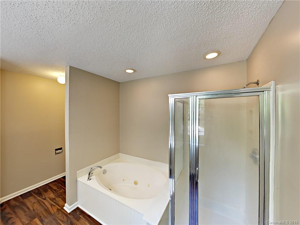 7315 Reedy Creek Road Charlotte, NC 28215 - Photo 12 of 18 a bathroom with a bathtub and a shower