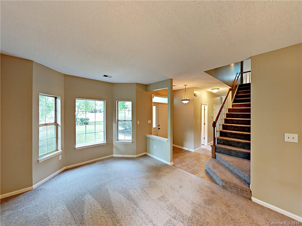 7315 Reedy Creek Road Charlotte, NC 28215 - Photo 4 of 18 a view of an empty room with glass door and windows