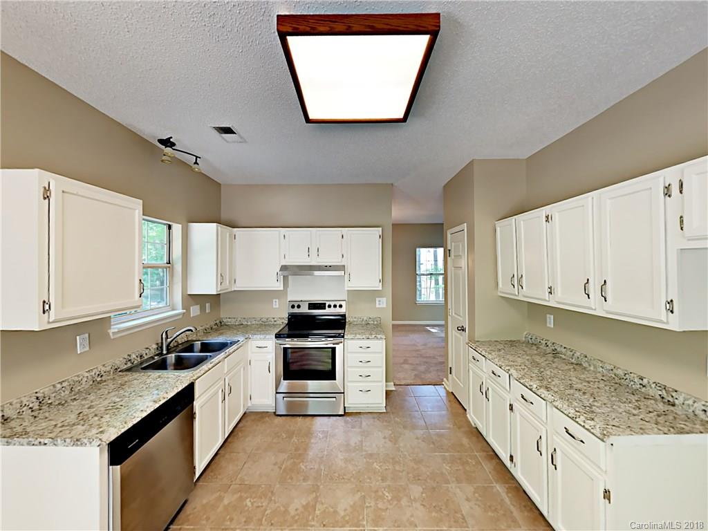 7315 Reedy Creek Road Charlotte, NC 28215 - Photo 6 of 18 a kitchen with stainless steel appliances granite countertop a stove a sink and a microwave