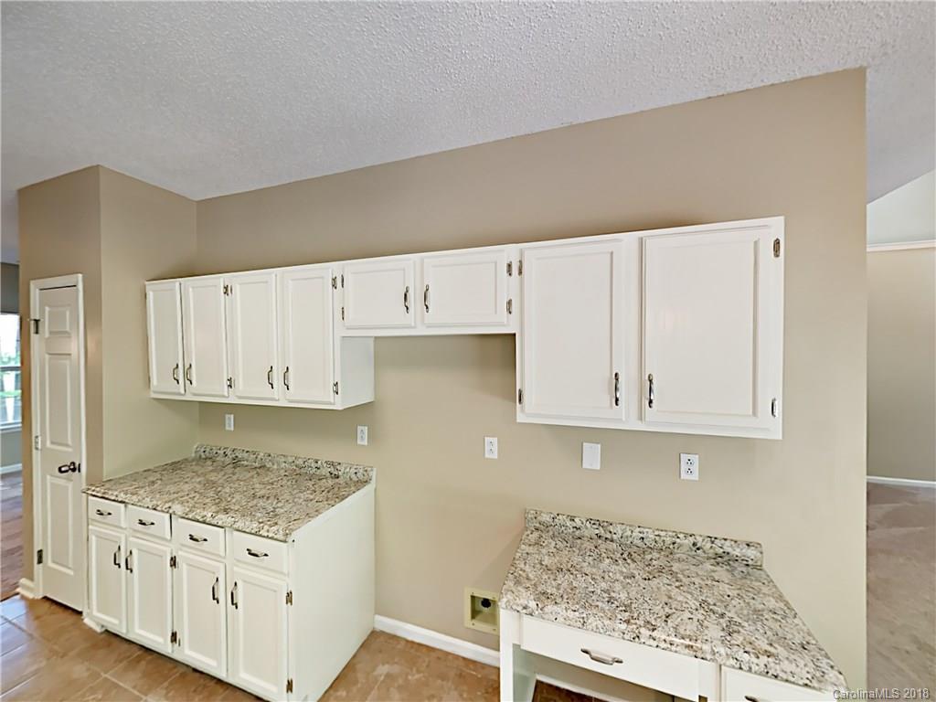 7315 Reedy Creek Road Charlotte, NC 28215 - Photo 7 of 18 a kitchen with granite countertop white cabinets and granite counter tops