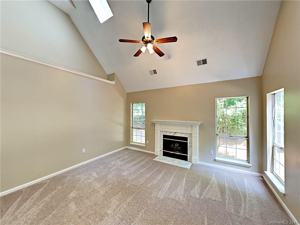 7315 Reedy Creek Road Charlotte, NC 28215 - Photo 8 of 18 a view of empty room with fireplace and windows
