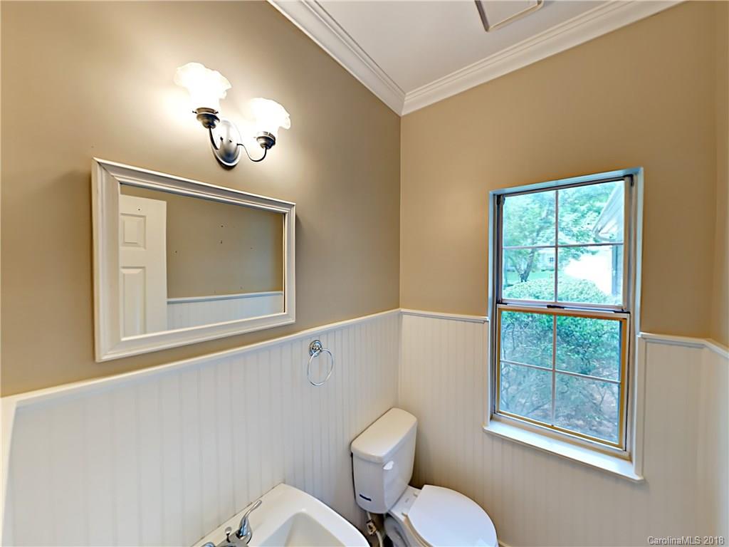 7315 Reedy Creek Road Charlotte, NC 28215 - Photo 10 of 18 a bathroom with a toilet a sink and mirror