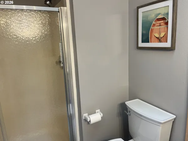 a bathroom with a toilet and a shower curtain