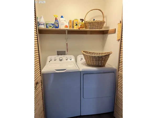 a close view of a sink and dishwasher with wooden floor