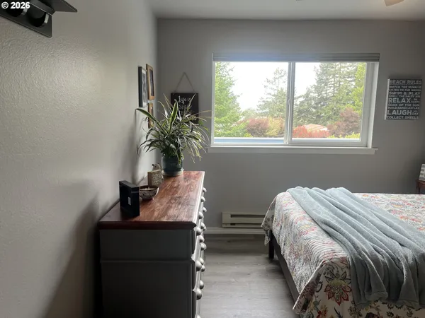 a bed sitting in a bedroom next to a window