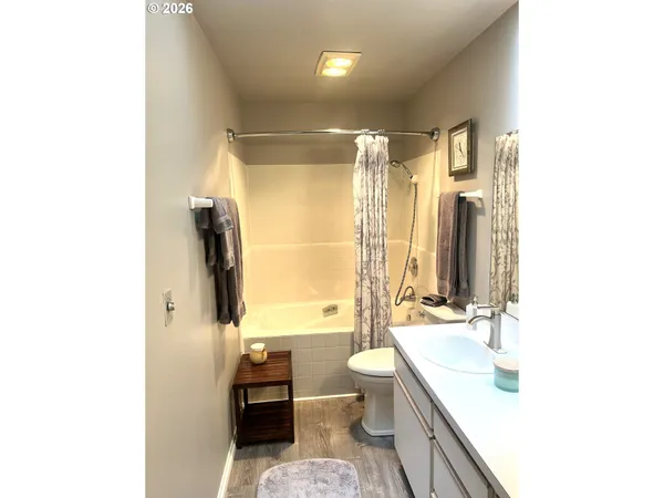 a bathroom with a double vanity sink toilet and shower