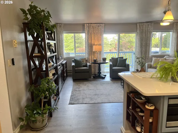 a living room with furniture and a potted plant