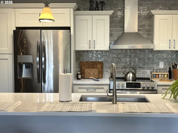 a kitchen with granite countertop a refrigerator and a stove