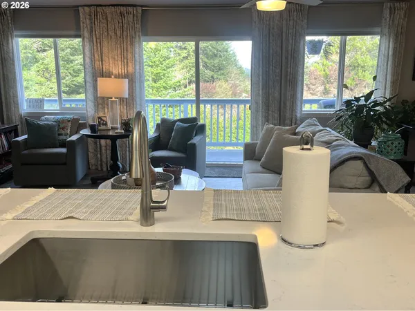 a living room with furniture and large windows