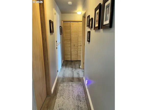 a view of a hallway with wooden floor