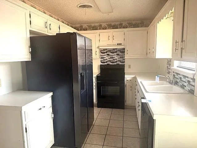 a kitchen with a refrigerator sink and stove