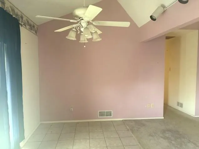 a view of a livingroom with a chandelier fan
