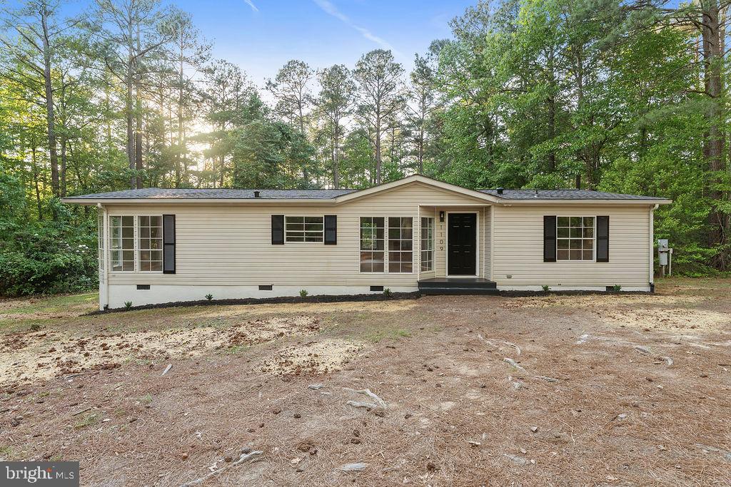1109 Eastham Road Bumpass, VA 23024 - Photo 2 of 26 a house with trees in the background