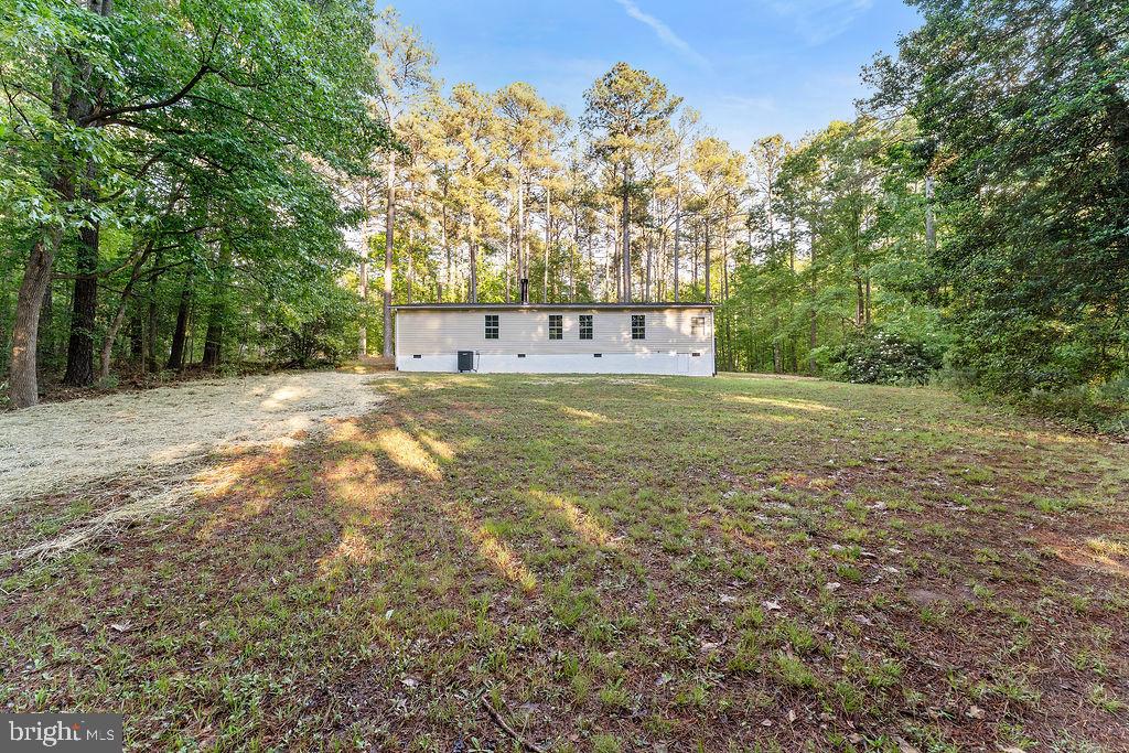 1109 Eastham Road Bumpass, VA 23024 - Photo 25 of 26 a view of a big yard with large trees