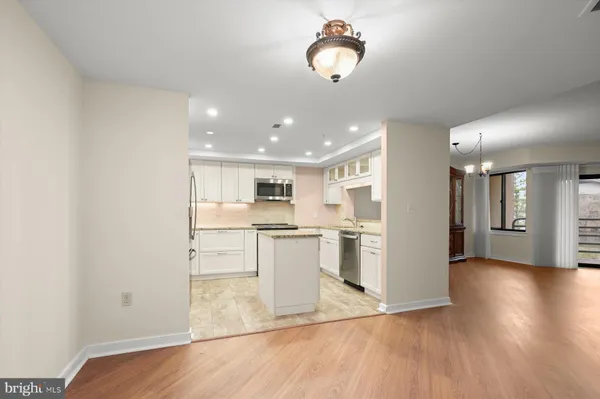 a view of kitchen with refrigerator microwave and stove