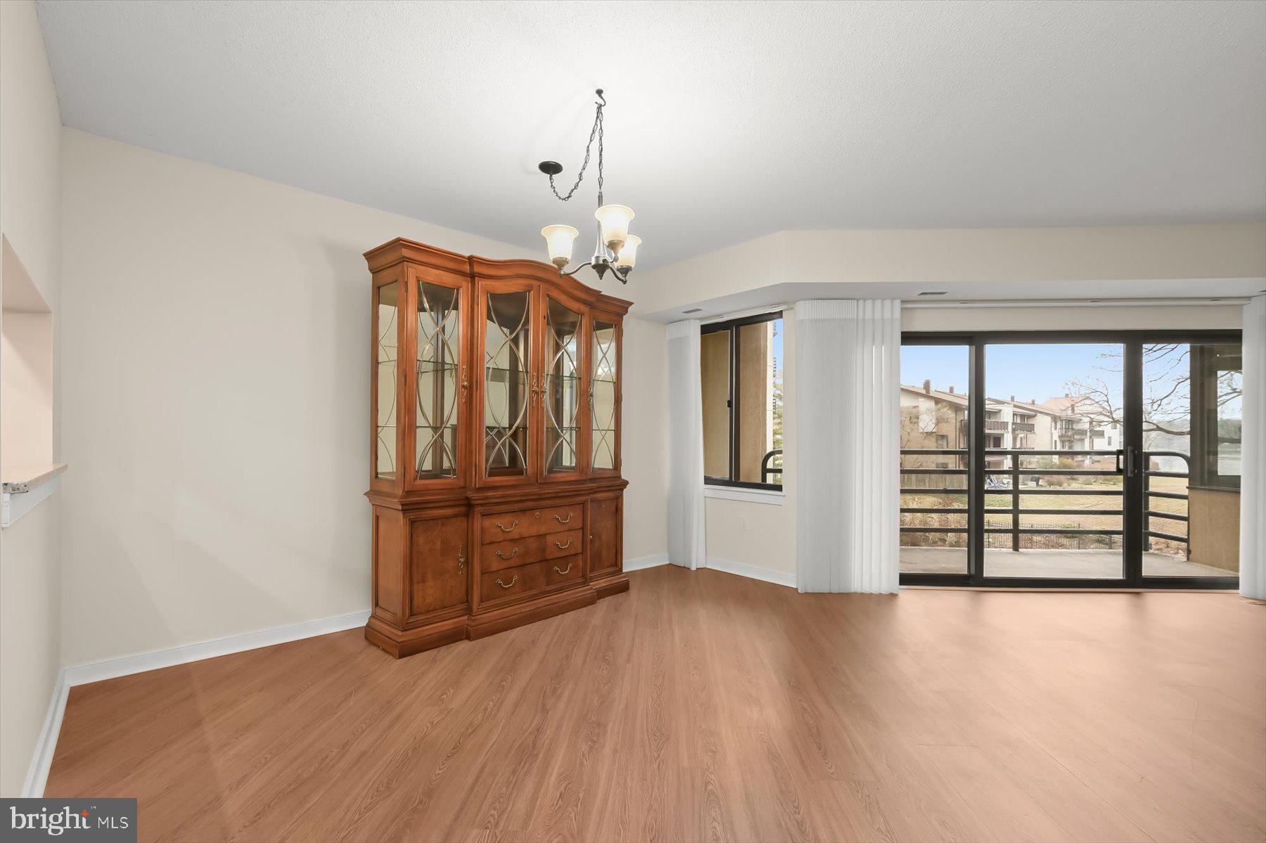 10001 Windstream Drive, Unit 404 Columbia, MD 21044 - Photo 14 of 51 wooden floor in an empty room with a window