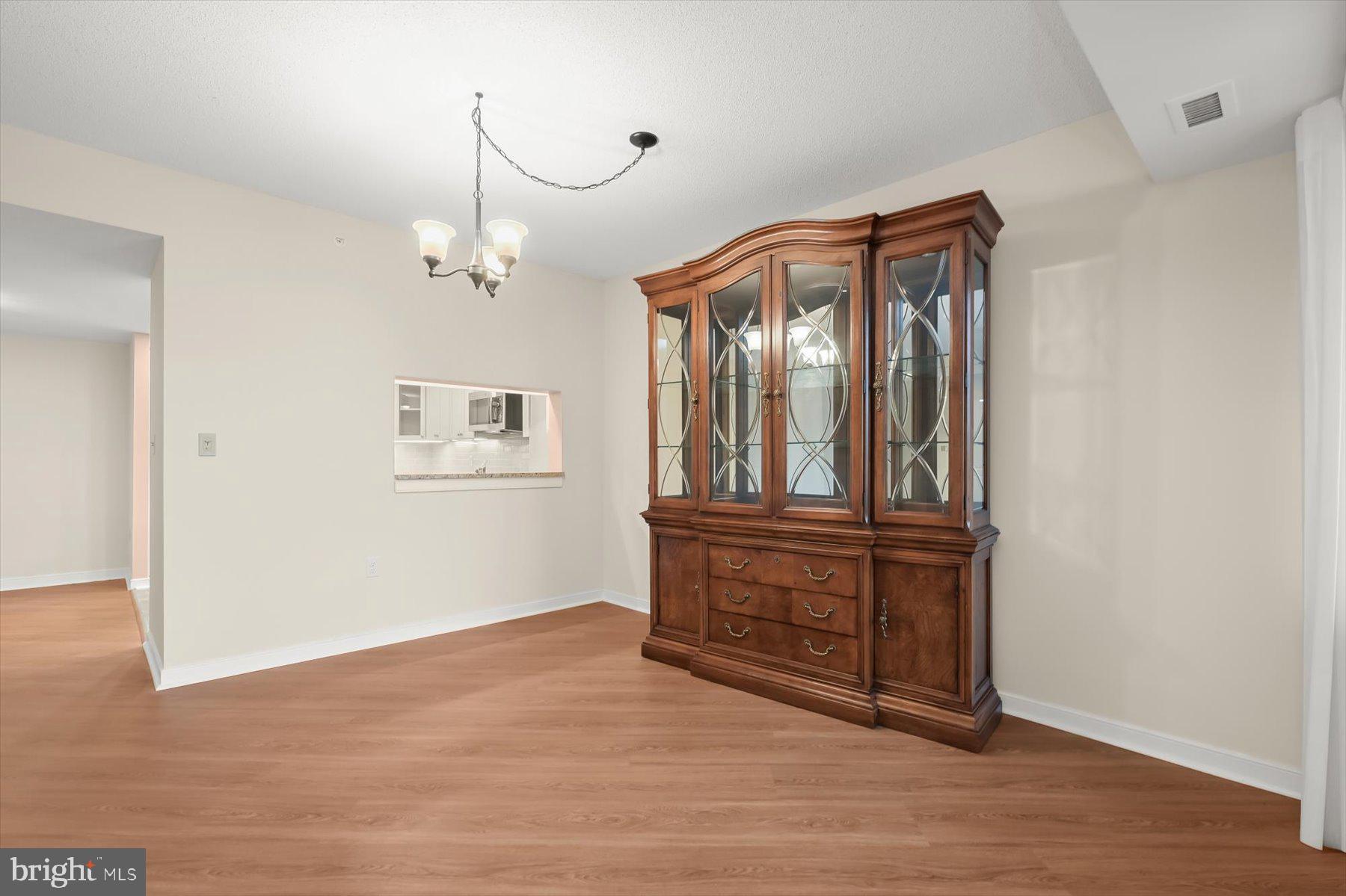 10001 Windstream Drive, Unit 404 Columbia, MD 21044 - Photo 15 of 51 a view of a hallway with wooden floor and cabinet