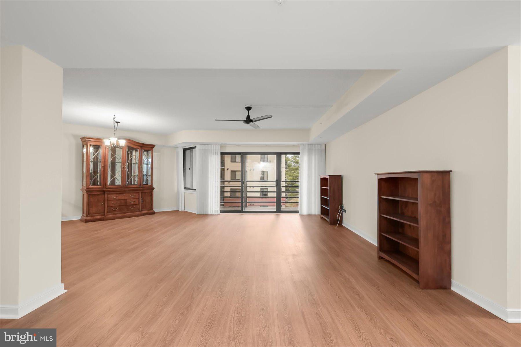 10001 Windstream Drive, Unit 404 Columbia, MD 21044 - Photo 16 of 51 an empty room with wooden floor and windows