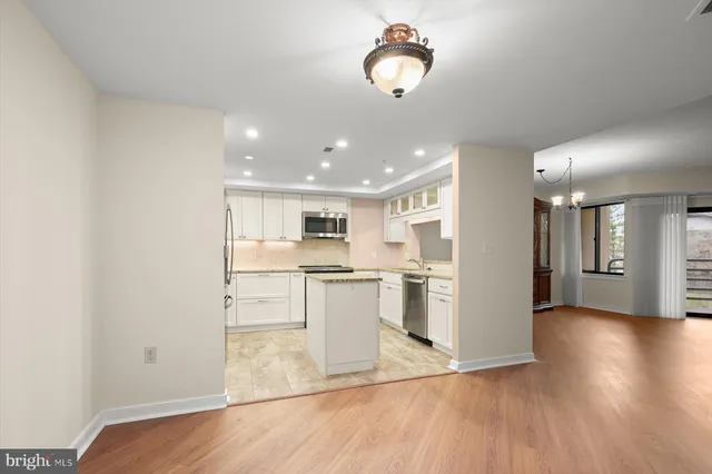 a view of kitchen with refrigerator microwave and stove