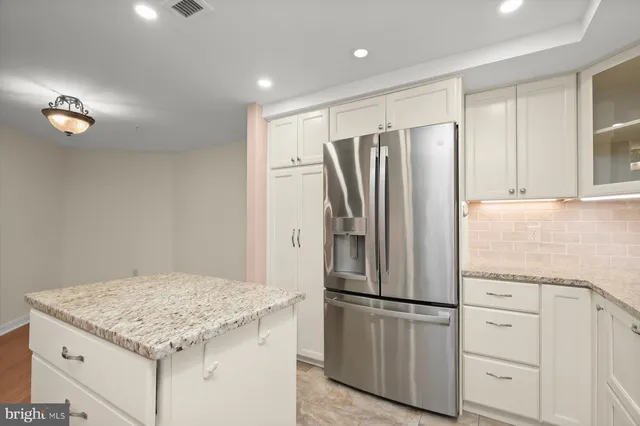 a kitchen with a refrigerator and a sink