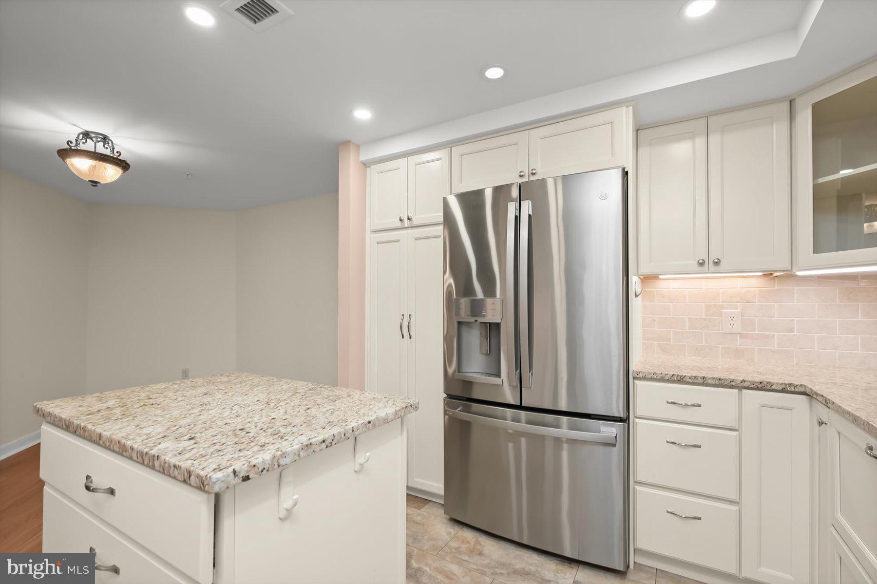 10001 Windstream Drive, Unit 404 Columbia, MD 21044 - Photo 20 of 51 a kitchen with a refrigerator and a sink