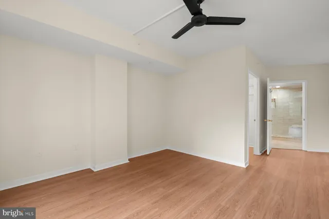a view of a big room with wooden floor and windows in a room