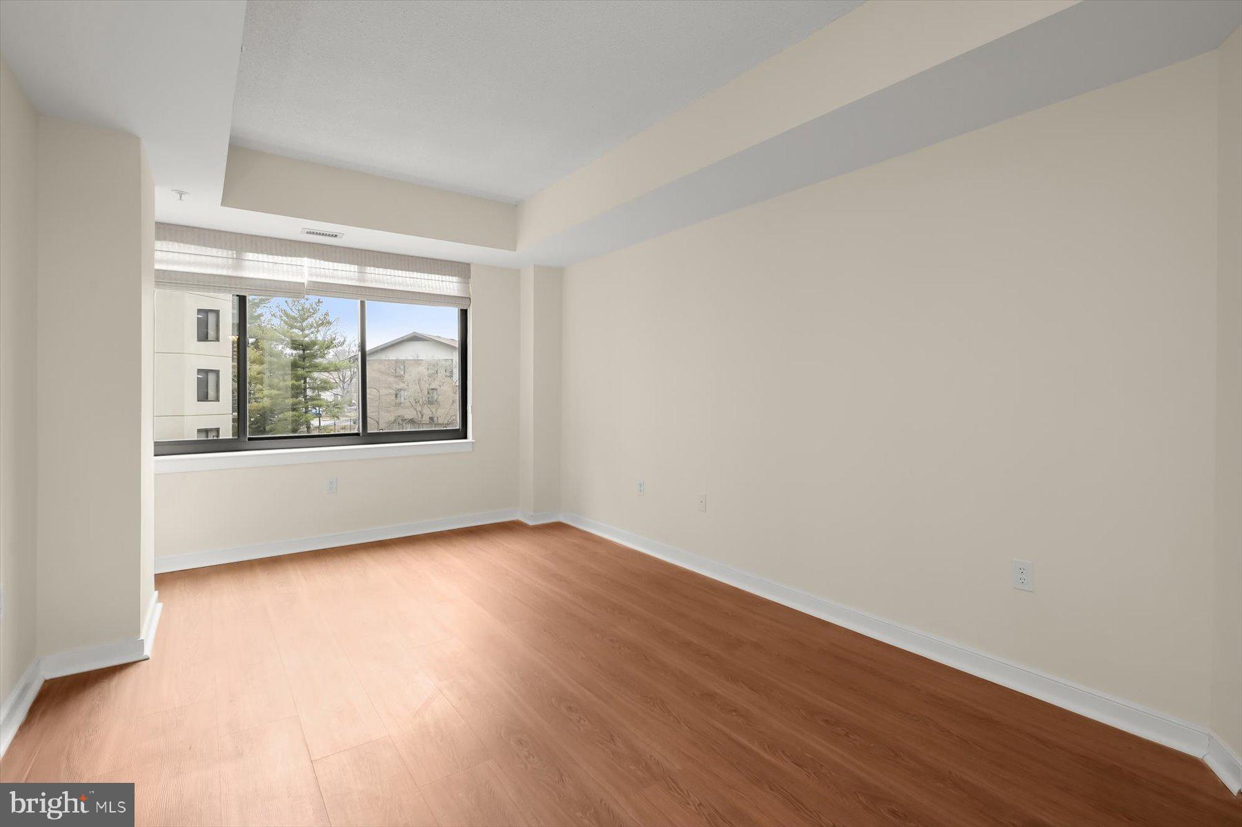 10001 Windstream Drive, Unit 404 Columbia, MD 21044 - Photo 35 of 51 an empty room with wooden floor and windows