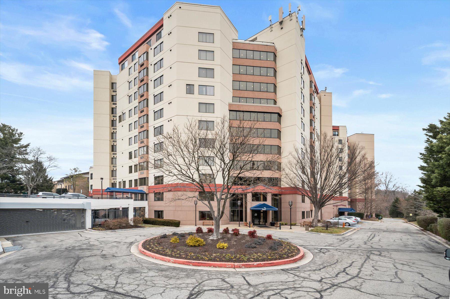 10001 Windstream Drive, Unit 404 Columbia, MD 21044 - Photo 41 of 51 a building with trees in front of it