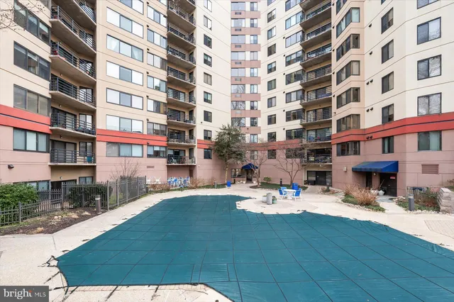 a view of swimming pool with outdoor seating and plants