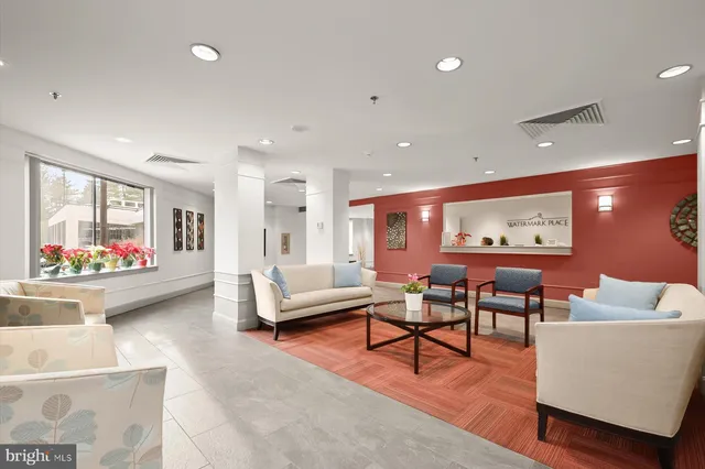a living room with furniture a counter space and a view of kitchen