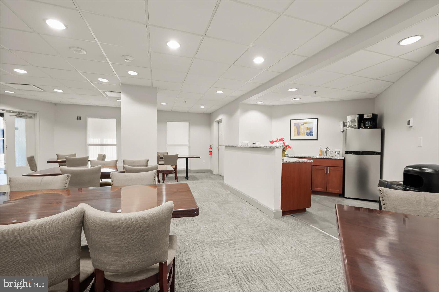 10001 Windstream Drive, Unit 404 Columbia, MD 21044 - Photo 49 of 51 a living room with furniture a counter space and a view of kitchen
