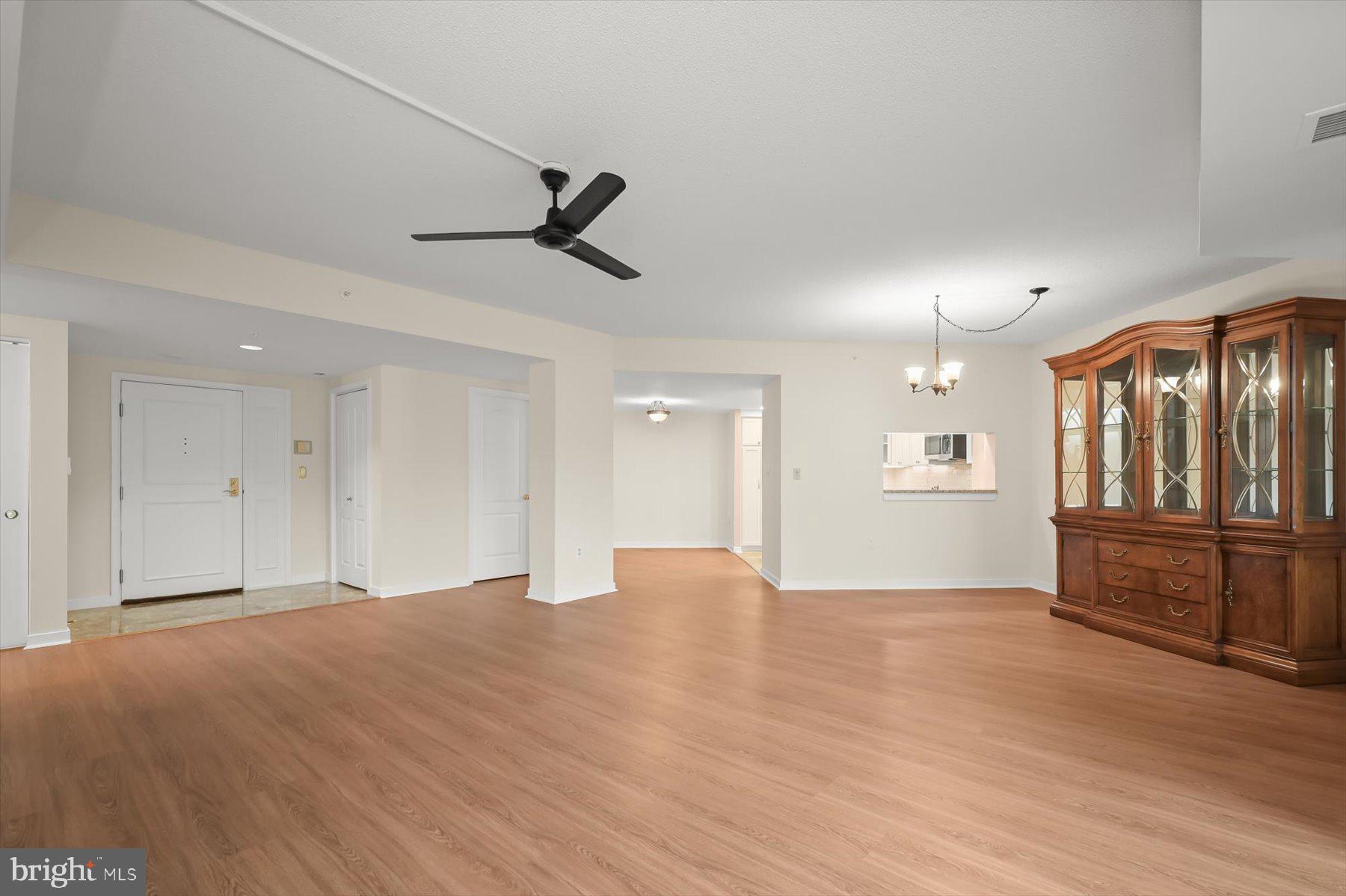 10001 Windstream Drive, Unit 404 Columbia, MD 21044 - Photo 8 of 51 a view of an empty room with a window and wooden floor