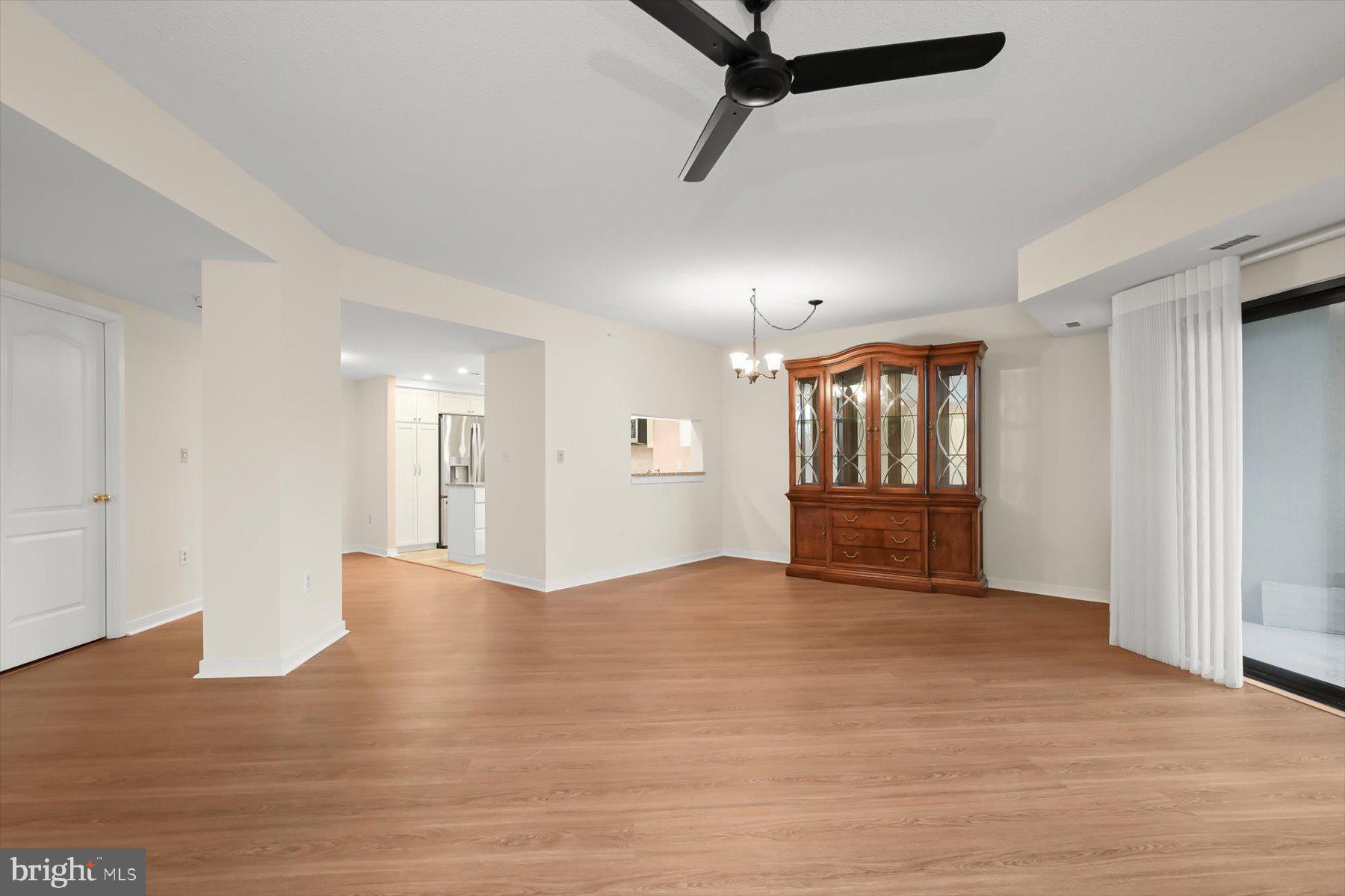 10001 Windstream Drive, Unit 404 Columbia, MD 21044 - Photo 9 of 51 a view of an empty room with a window and wooden floor