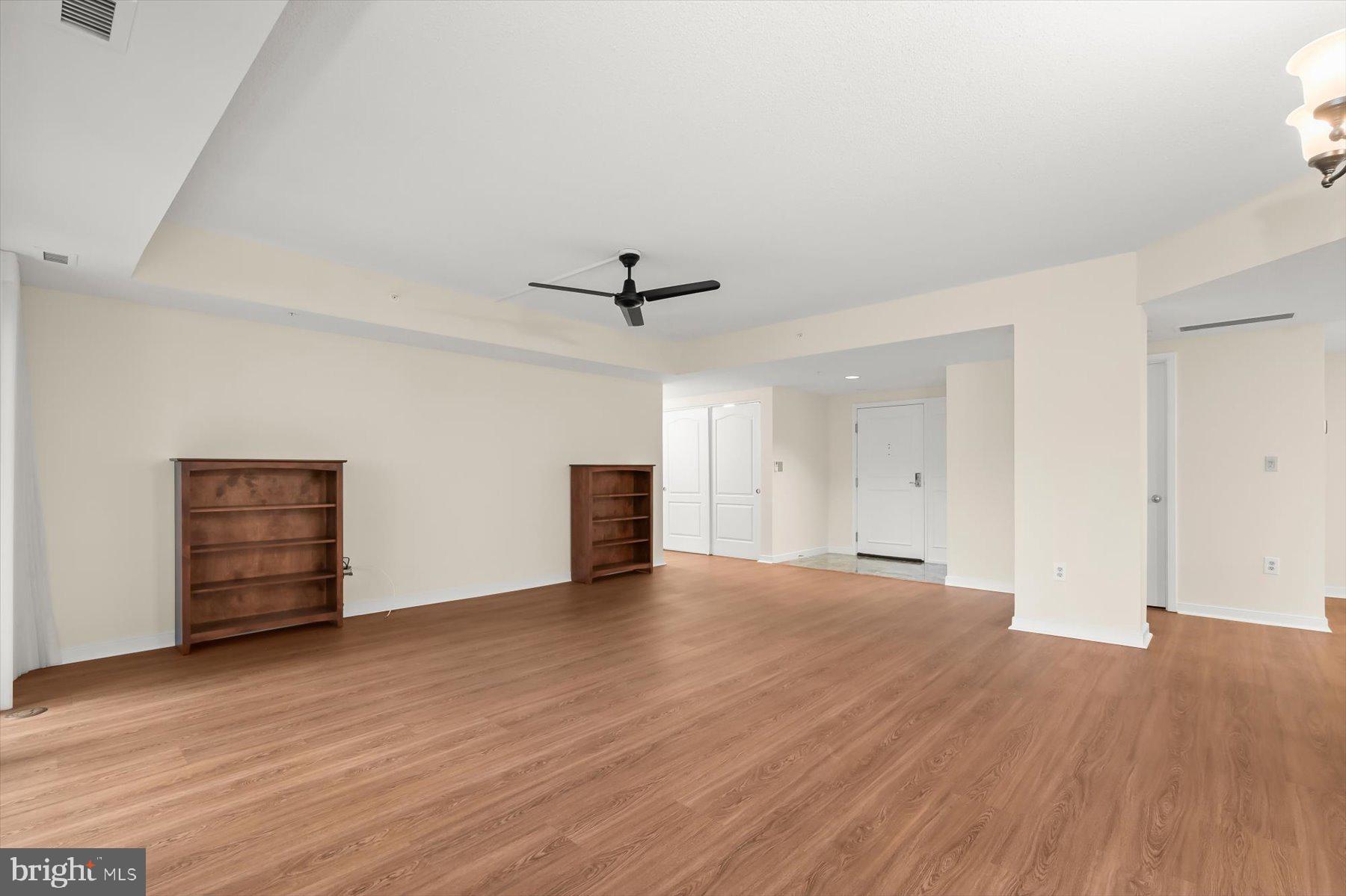 10001 Windstream Drive, Unit 404 Columbia, MD 21044 - Photo 10 of 51 a view of an empty room with wooden floor and a ceiling fan