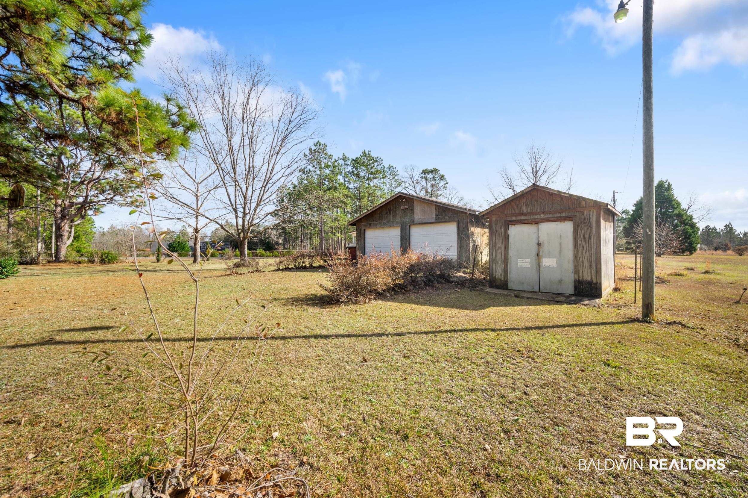 57623 Mary Hadley Road Perdido, AL 36562 - Photo 26 of 34 View of grassy yard featuring an outdoor structure