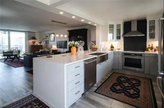 a kitchen with stove a sink and a refrigerator