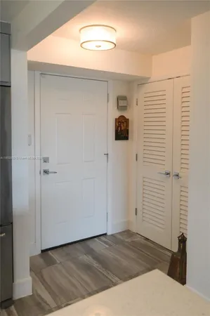 a view of a hallway to rooms