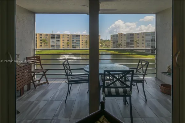 a dinning table sitting next to a window