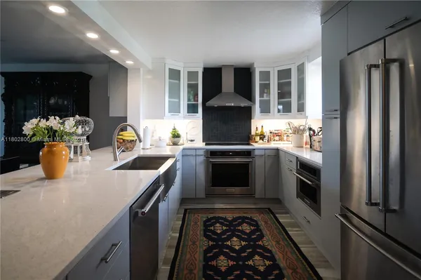 a kitchen with a stove and a refrigerator