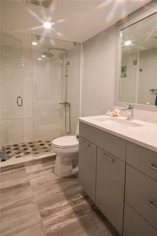 a bathroom with a sink a mirror and a shower