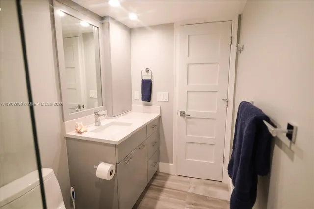 a bathroom with a double vanity sink toilet and a shower