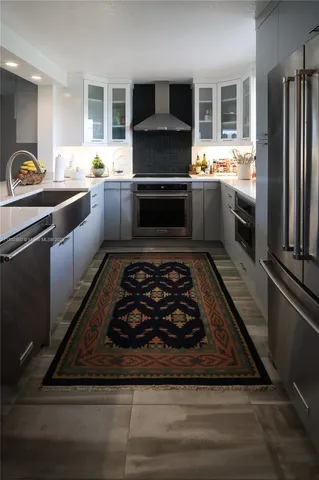 a kitchen with stainless steel appliances granite countertop a stove a sink and a refrigerator