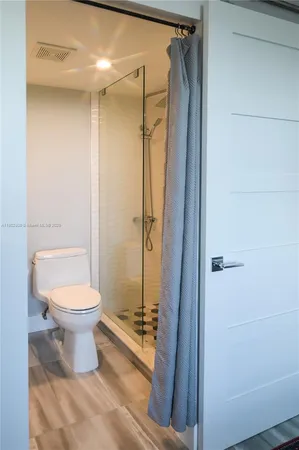 a bathroom with a sink a toilet and mirror