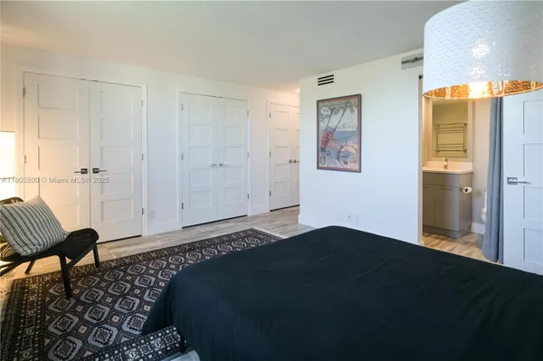 a bedroom with a bed and a mirror