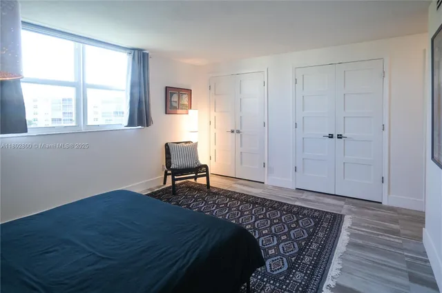 a bedroom with a bed chair and a window