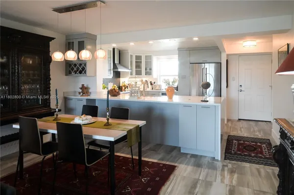 a kitchen with stainless steel appliances kitchen island granite countertop a sink and cabinets