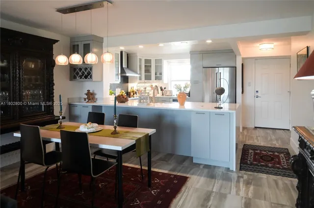 a kitchen with stainless steel appliances kitchen island granite countertop a sink and cabinets