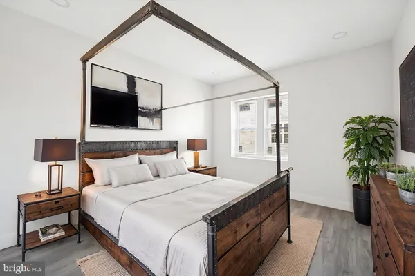 a bedroom with a bed and a flat screen tv